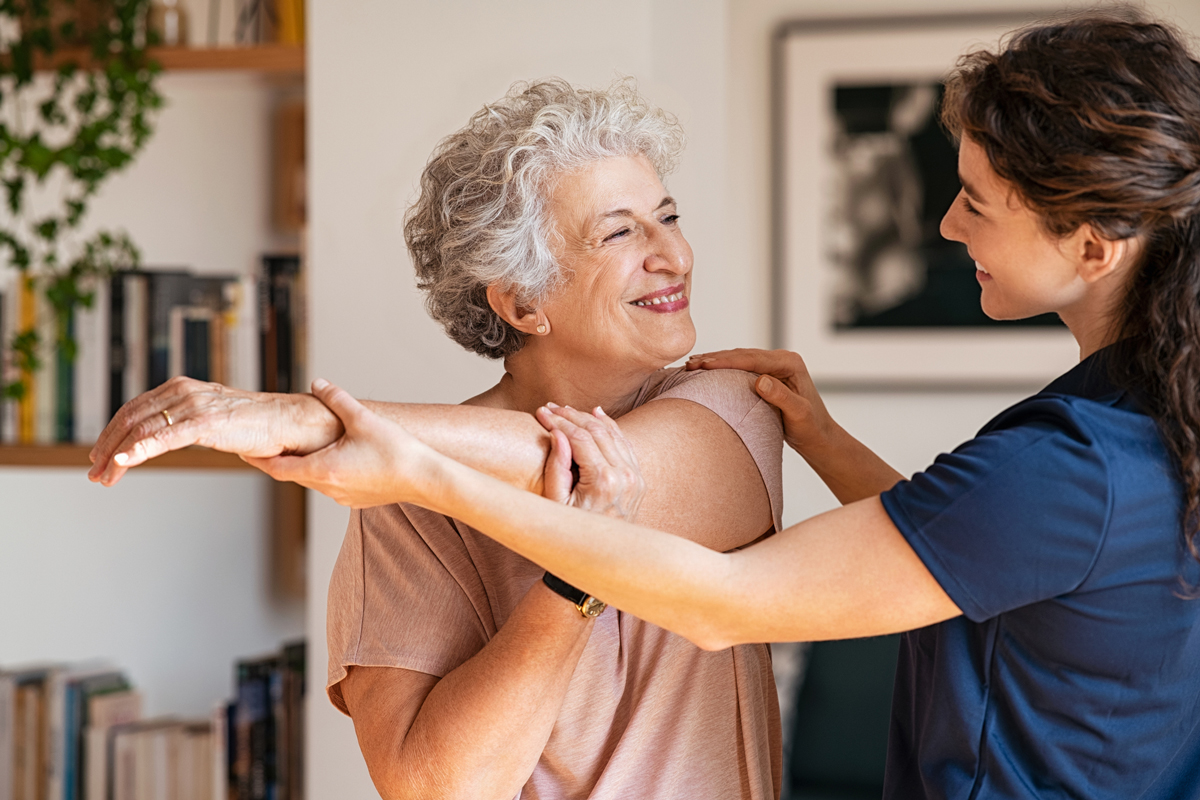 Senior woman receiving rehab therapy at assisted living facility